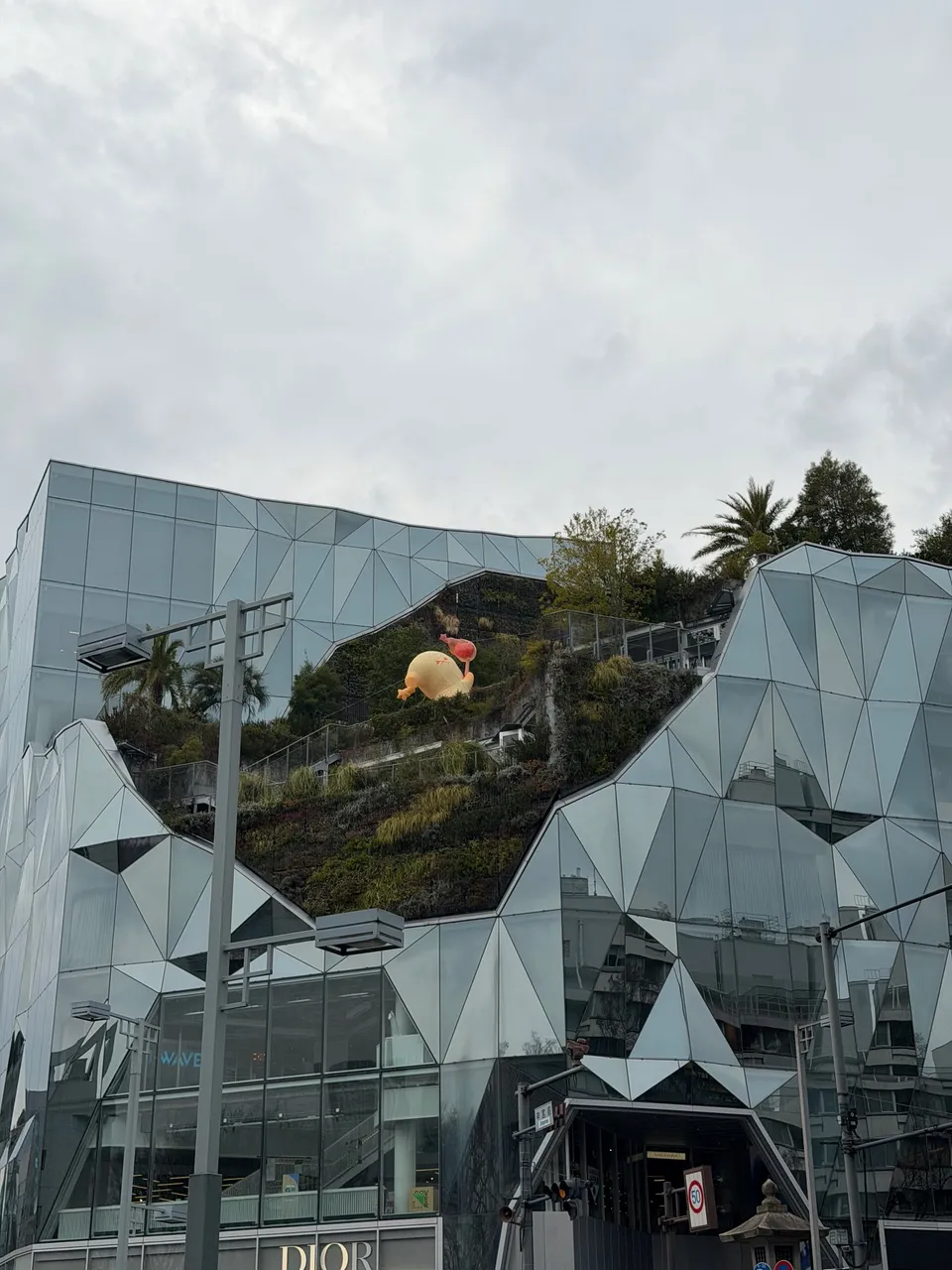 Hoekige glazen gevel met beplanting van een modewinkel aan de Omotesando in Tokyo