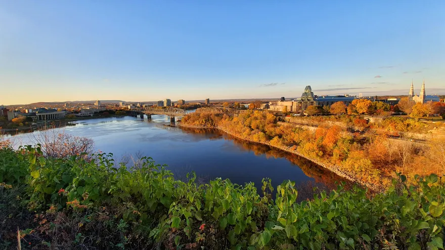 De Ottawa-rivier met bossen in oranje en rood herfstblad aan beide oevers